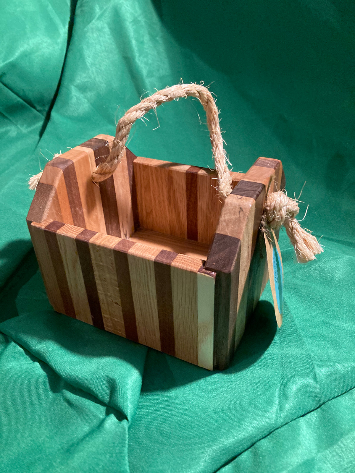 Small wood box with rope handle.