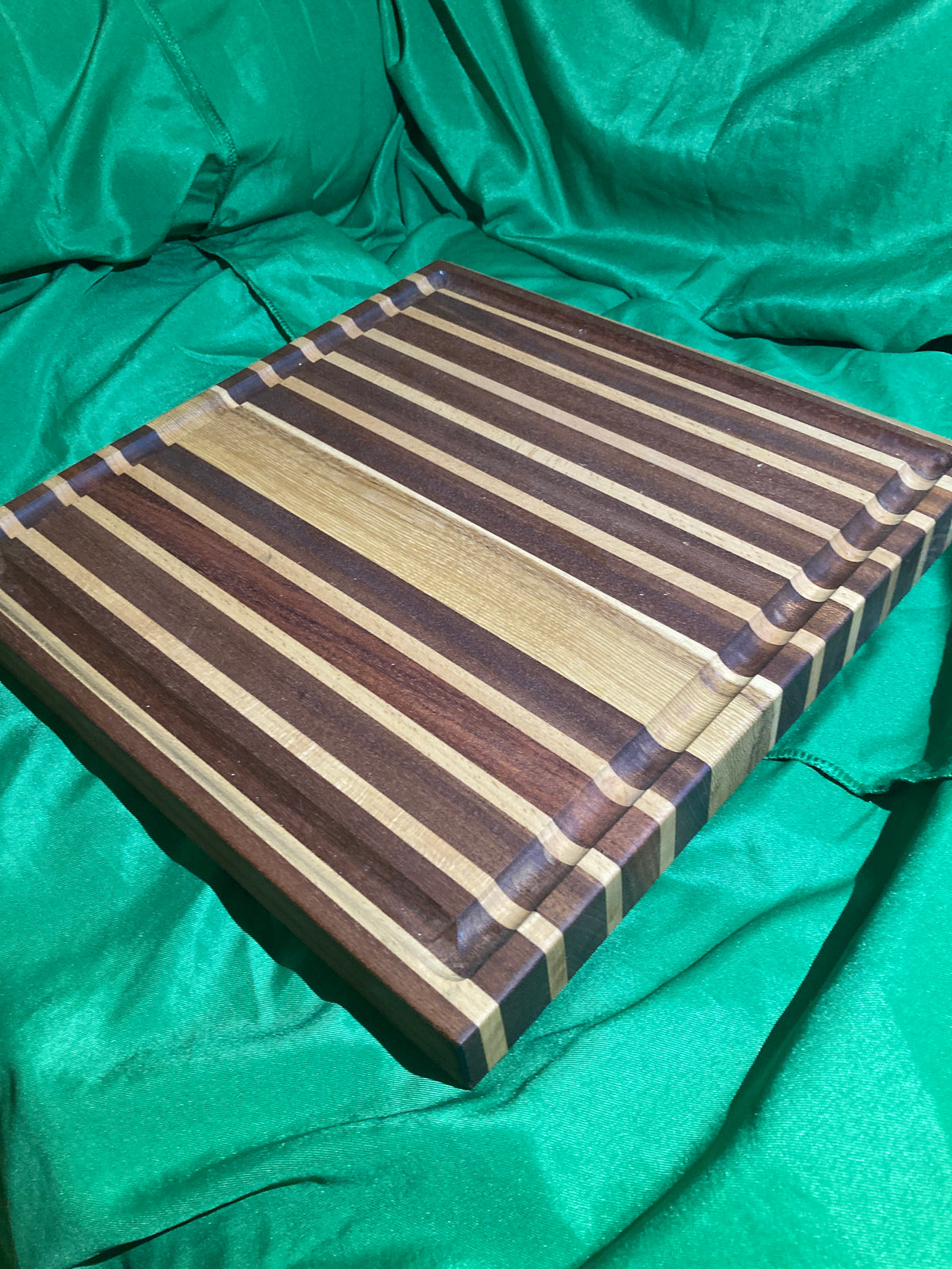 Large cutting board with juice groove. Handcrafted reclaimed wood. Jatoba wood. Hickory wood. Board with feet.