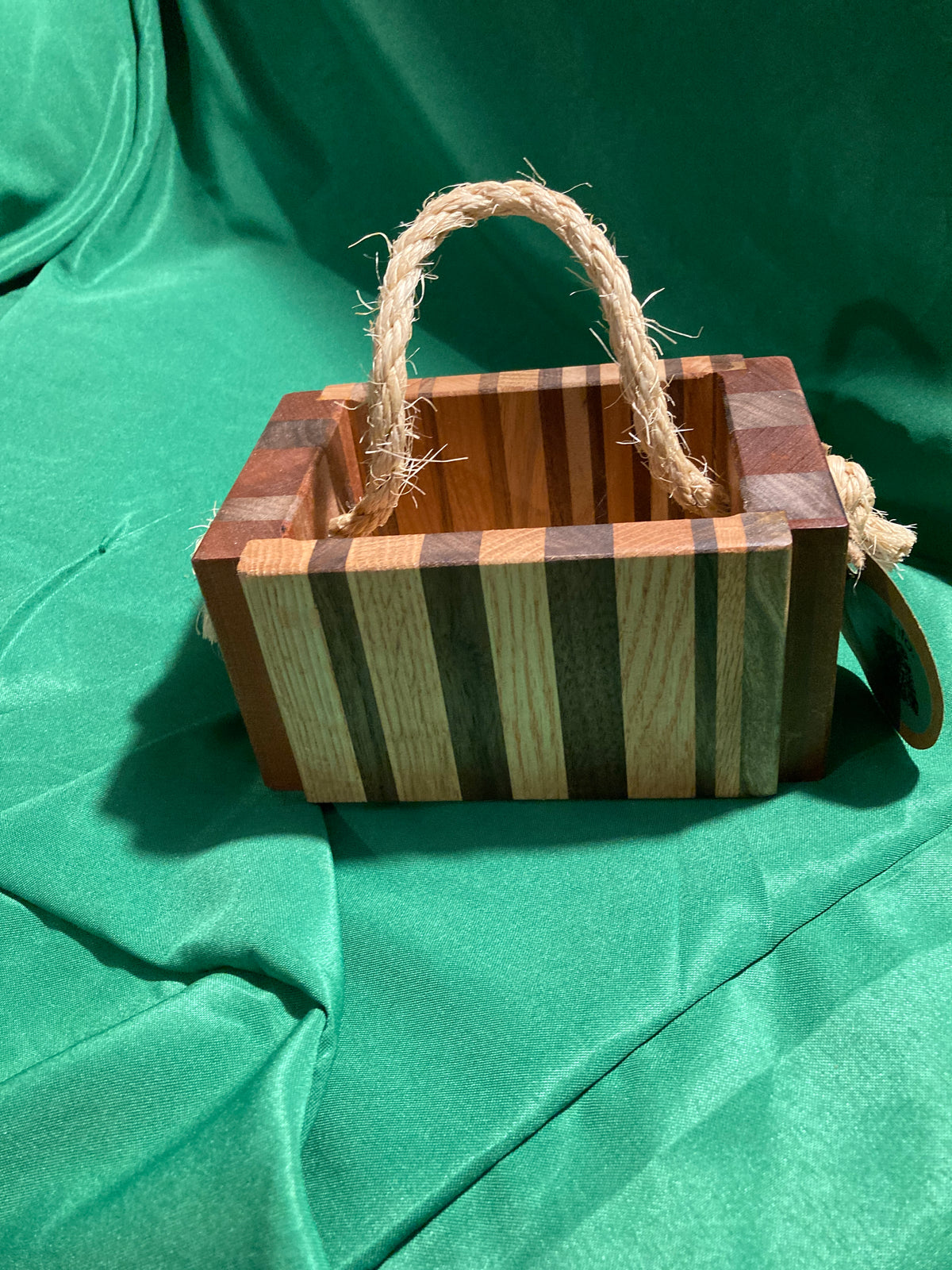 Small wood box with rope handle.