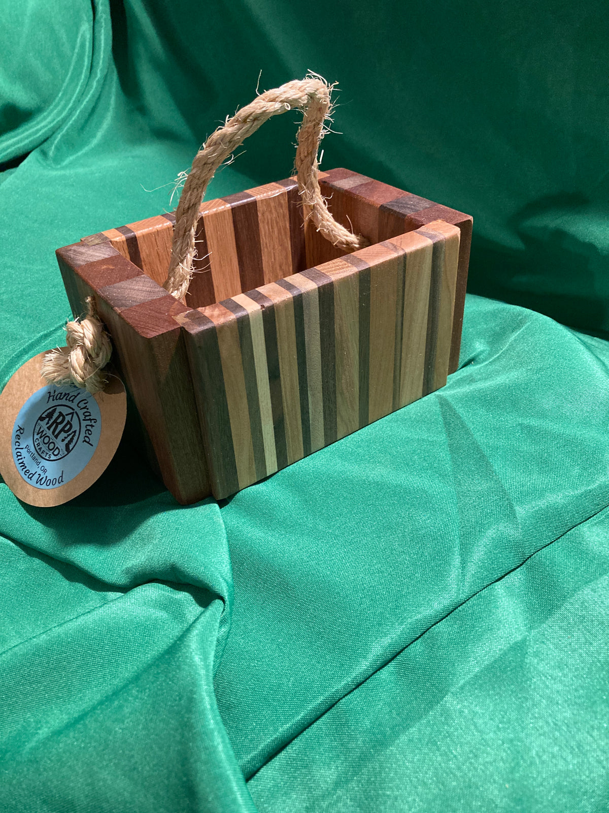 Small wood box with rope handle.