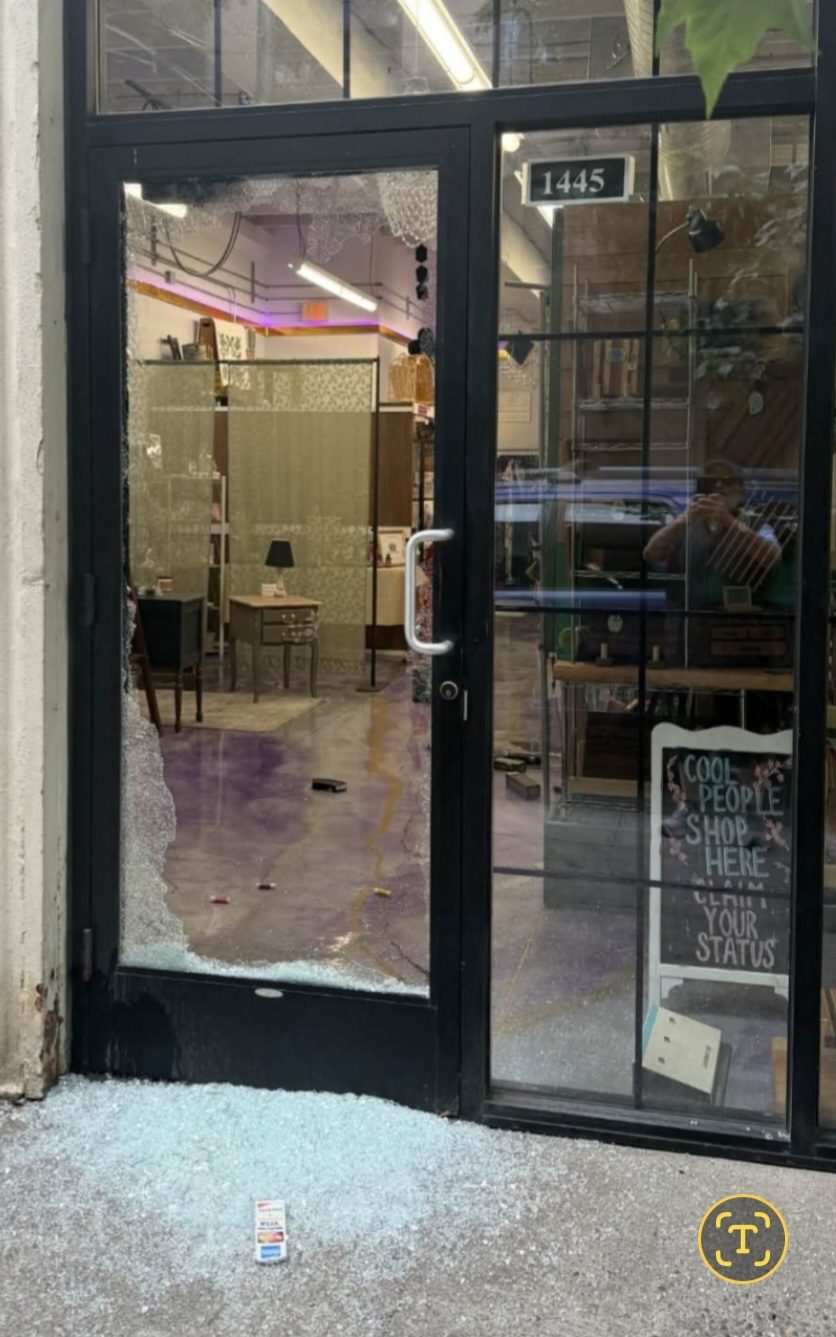 The front door of Lost & Found with its glass shattered, broken glass covering the sidewalk