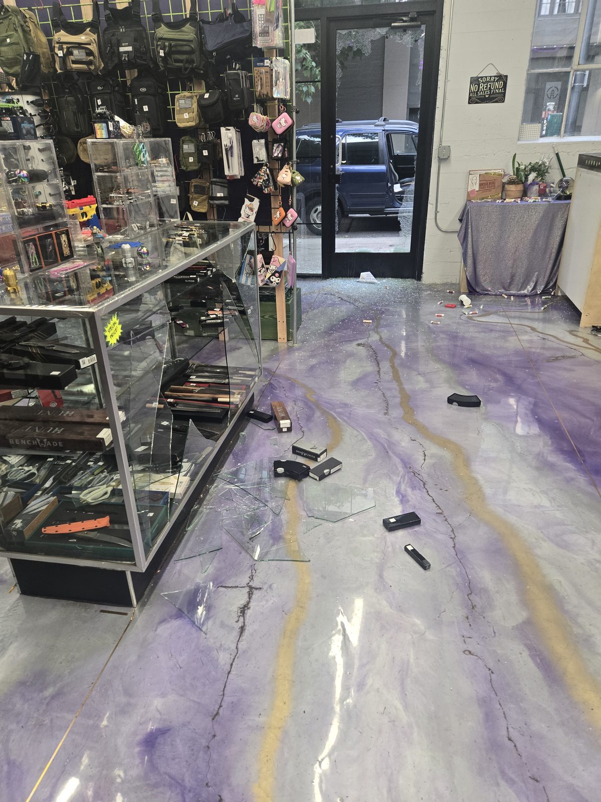 Shattered display case glass scattered across the shop floor